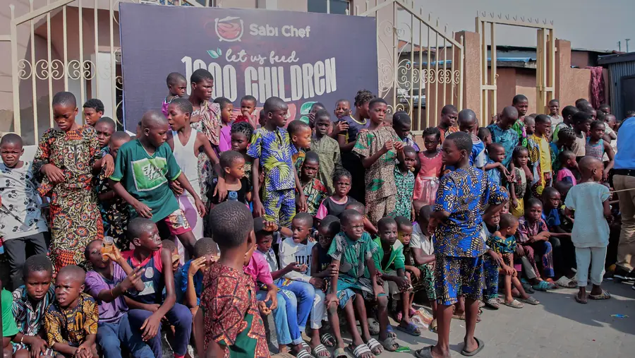 Children and adults posing together outside the event venue